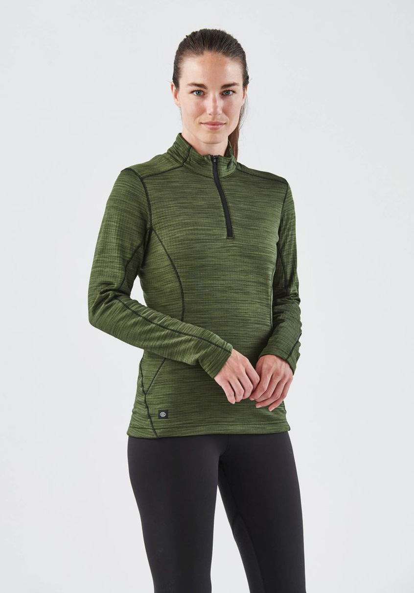 Woman in a green quarter-zip thermal pullover against a plain background.